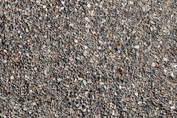 Detailed close-up of pea gravel showcasing texture and color variations, ideal for backgrounds and design projects.