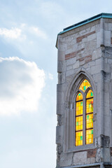 Medieval church tower ruin with colorful stained glass windows
