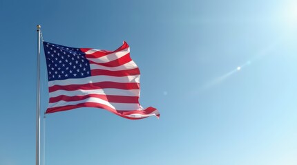 Waving American flag against a clear blue sky on Independence Day celebration in July