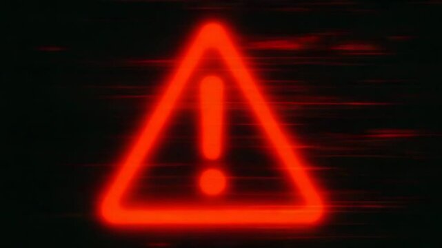 A bright red warning sign appears against a dark background. The symbol captures attention, conveying urgency and alertness, perfect for themes involving caution and safety.