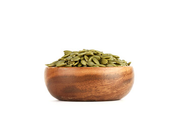Peeled pumpkin seeds in a bowl on a white background.