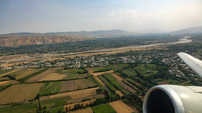 A breathtaking aerial view showcasing the Kafirnigan River and the picturesque suburbs of Dushanbe city