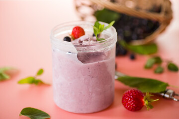 Blackcurrant ice cream with strawberries on pink