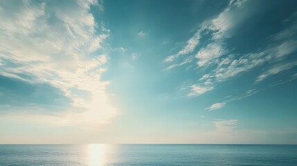 Obraz premium Serene Ocean View at Sunrise with Soft Clouds and Clear Sky Above