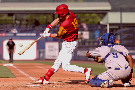 baseball player #19 making contact