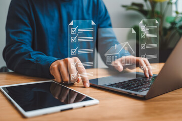 A person with a laptop displaying a virtual house and checklist, symbolizing online real estate management, house investment. A tablet rests nearby on a wooden desk, emphasizing digital efficiency.