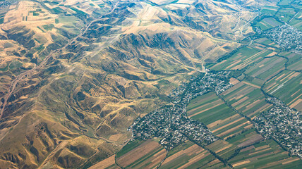 An Aerial View of Mountainous Terrain and Bustling Agricultural Fields in Vibrant Colors