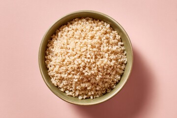 Ceramic Bowl of Cooked Brown Rice on Pastel Beige Background