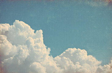 Vintage sky with fluffy white clouds, blue sky, and a faded yellow border for an old-fashioned feel. Vintage-style sky with white clouds, blue sky