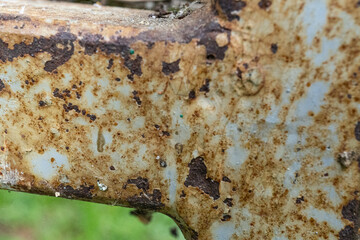 Rusty metal surface with peeling paint and textured details