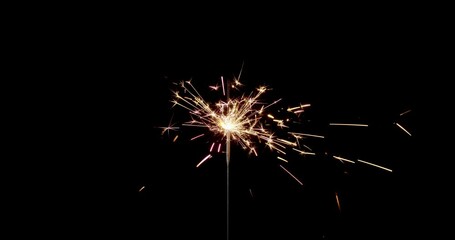 Lightening sparkler on the black background. Sparkler concept. Bengal lights are burning on a black background. Holiday party concept. New year party sparkler. Slow motion.