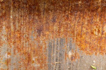 Weathered rusted metal surface with vertical patterns and textures