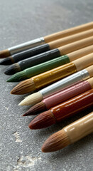 Fototapeta premium Watercolor paintbrushes on grey surface background.