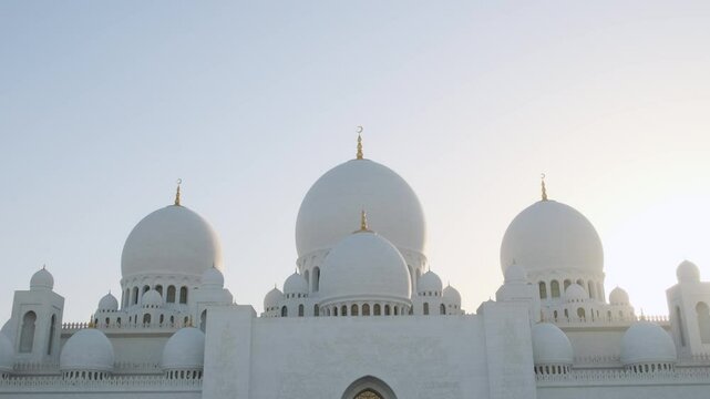 View of Sheikh Zayed Grand Mosque in Abu Dhabi, UAE, one of the largest mosques in the world. White marble domes, minarets, and intricate carvings of Islamic art and architecture