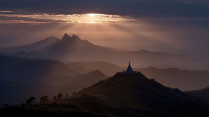 Scenic twilight scene of a pagoda framed by distant peaks and streaks of sunlight at sunset