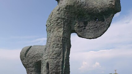 Monument commemorating pivotal didgori battle, standing as enduring symbol of georgian historical significance amid verdant landscape under bright summer sky