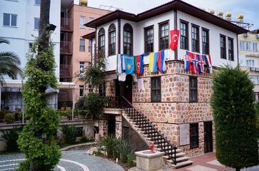 Historic Stone Building Adorned With Flags in a Vibrant Urban Square