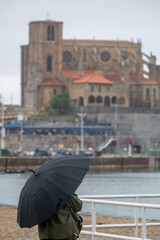umbrella in the rain in the city of castro Urdiales in Spain