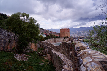 Ancient Castle Tower and Walls Overlooking a Scenic Urban Landscape