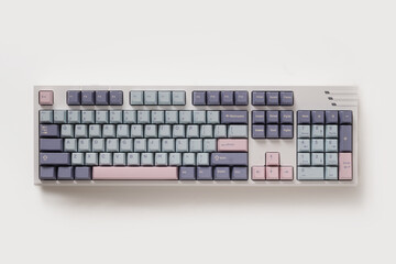 Mechanical pastel colored keyboard on white background. Minimal style and design keyboard. Custom...