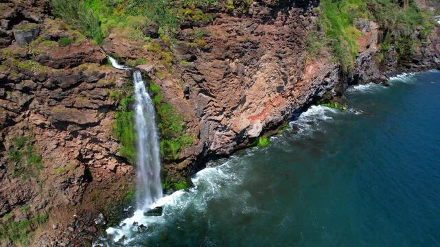 Ponta do Sol Madeira Drone 4K: Coastal Waterfall Cascata dos Anjos Falling into Ocean, Scenic Pebble Beach and Colorful Village, Portugal Travel Atlantic Islands 