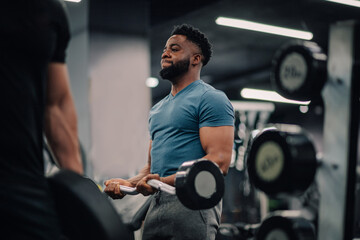 Determined bodybuilder lifting weights in modern gym