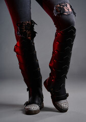 Close-Up of Stylish Black Boots With Riveted Design on Grunge Background