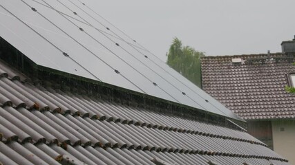 Solar panels installed on a sloped roof, capturing sunlight during a rainy day, showcasing renewable energy technology and sustainable living in an urban residential environment