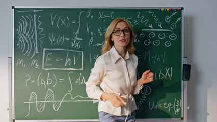 Fototapeta na wymiar Woman explaining math formulas to unknown students closeup. Smiling teacher
