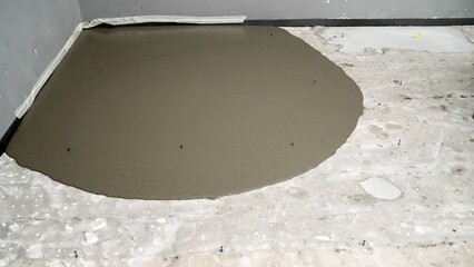 Construction worker leveling concrete floor using trowel. Construction worker leveling wet concrete...