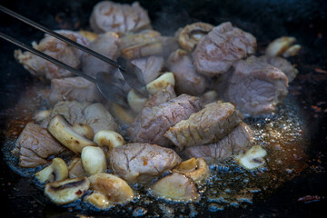 Frying pork steak in hot oil in a pan