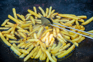 Frying French fries in hot oil