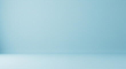 A simple studio setup with a light blue background and floor creating a minimalist backdrop scene