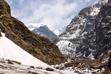 Explorers traverse the Annapurna trekking path, surrounded by towering mountains and stunning...