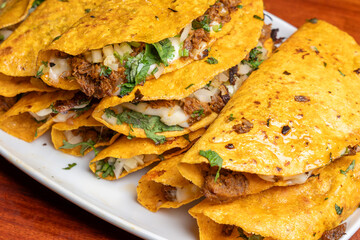 Close-up of crispy Mexican quesabirria tacos filled with birria meat and cheese