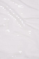 White sequin background. White shiny sequin fabric.