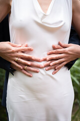 Embracing Hands on Wedding Day Highlighting Rings