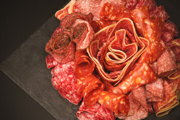 Different kinds of meat cuts on a board.