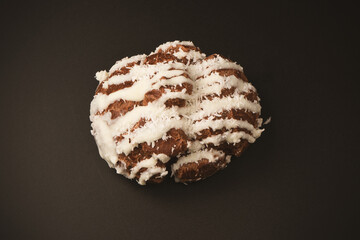 Profiteroles with coconut cream on a black background.