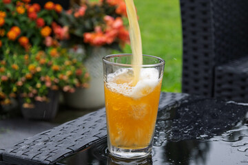 Full framed still shot of a beer pouring into a glass. A faster shutter speed shows motion in the shot