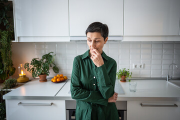 Sad pensive mature woman standing lost in sorrowful thoughts waiting. Loneliness isolation, emotional struggle, mental health, grief reflection, quiet despair, inner turmoil, difficult life phase