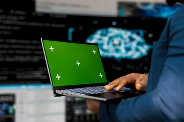 Young engineer works on binary code with copy space on laptop, reflecting the mindset of a tech...