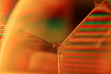 Orange coloured liquid surface, fluid effect, bright chemistry