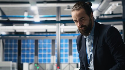 Executive consultant oversees solar energy systems in industrial workplace, emphasizing strategic...