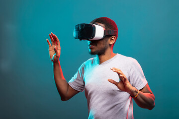 African American adult experiencing virtual reality game, fully immersed in 3D digital world using...