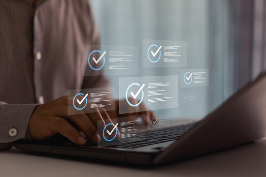 Businessman typing on laptop. Business evaluation and performance tracking in cyberspace using online checklist survey assessment platform quality assurance technology digital form and review process.