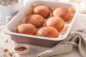 Hot and brown flax seed rolls made of sourdough.