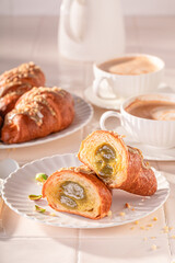 Tasty and traditionally pistachio croissants served with coffee.