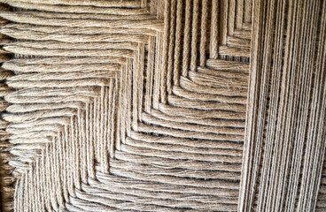 Detailed close-up view of woven textile showcasing the intricate patterns and textures of natural...