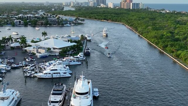 4K drone footage of boats navigating through the canal near the 17th Street Causeway Bridge, also known as the E. Clay Shaw Jr. Bridge, in Fort Lauderdale, Florida. 